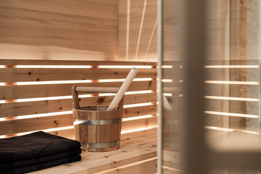 Private sauna, sauna area with towel and water bucket