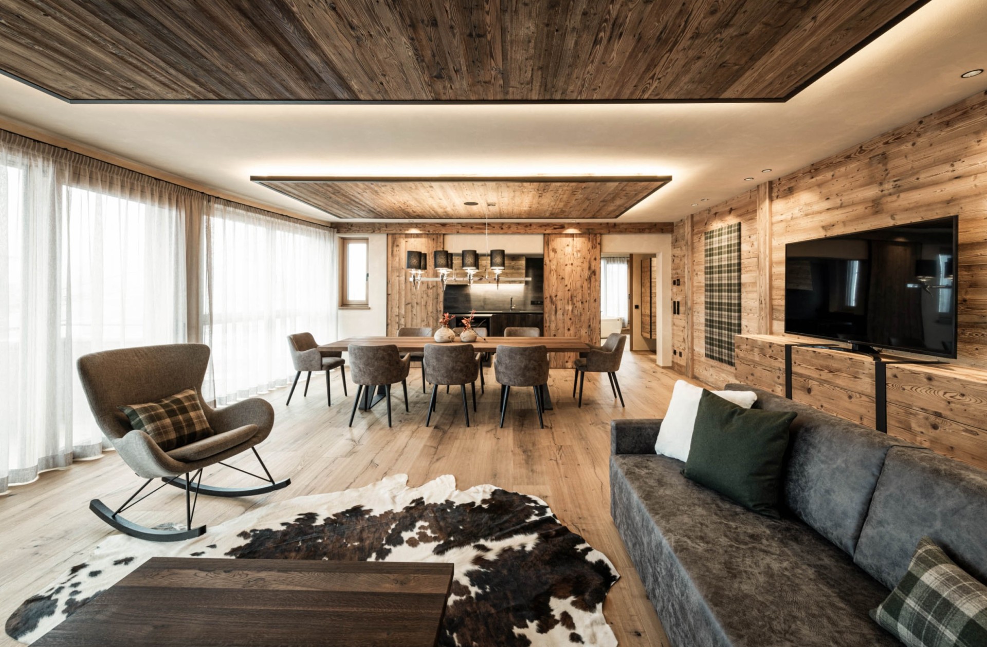 Modern large living and dining area with cowhide and lots of wood