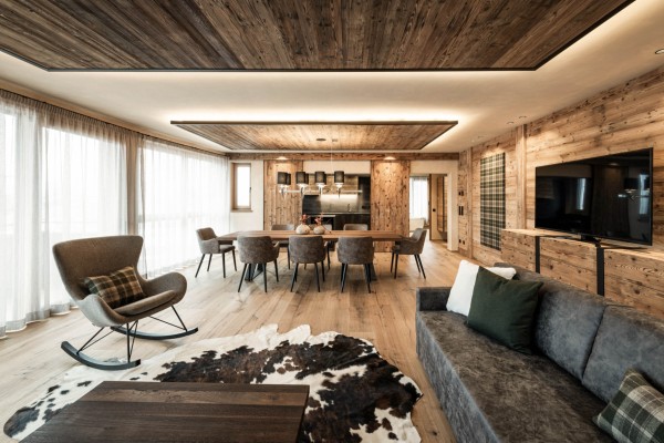 Modern large living and dining area with cowhide and lots of wood
