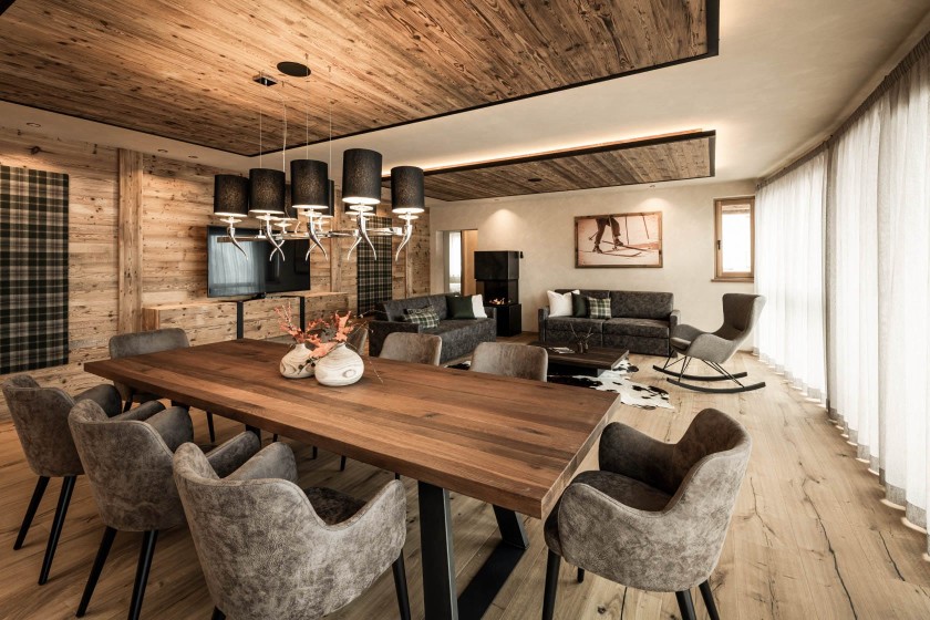 Alpine charm in the living and dining area, large table, couch and rocking chair