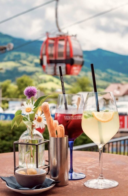 Genießen Sie Cocktails mit Ausblick auf die Kitzbüheler Berge und die Gondel