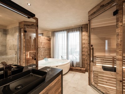 Spacious bathroom with bathtub and private sauna