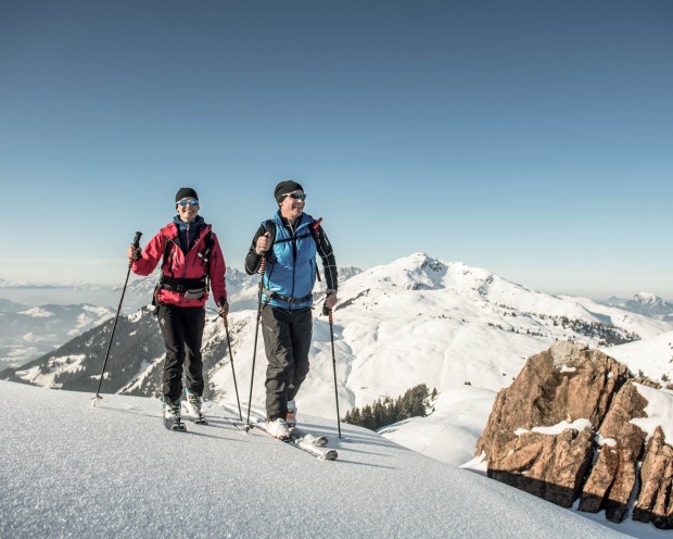 Cross-country skiing surrounded by snow-covered mountain landscapes